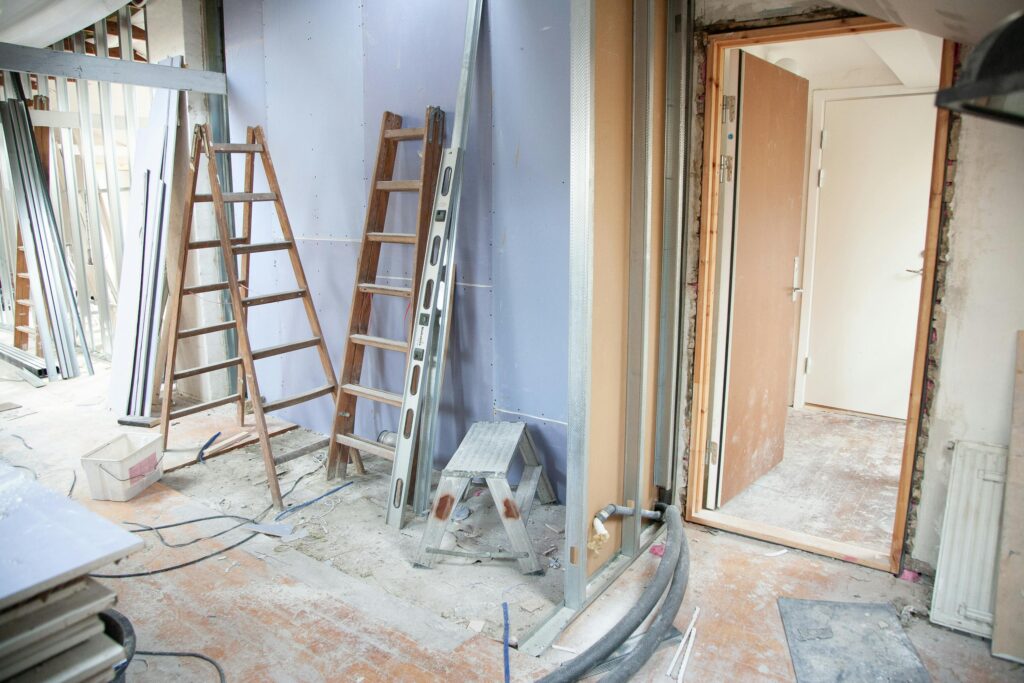 pexels-photo-3990359-3990359 Construction site featuring ladders and tools in a home renovation setting.